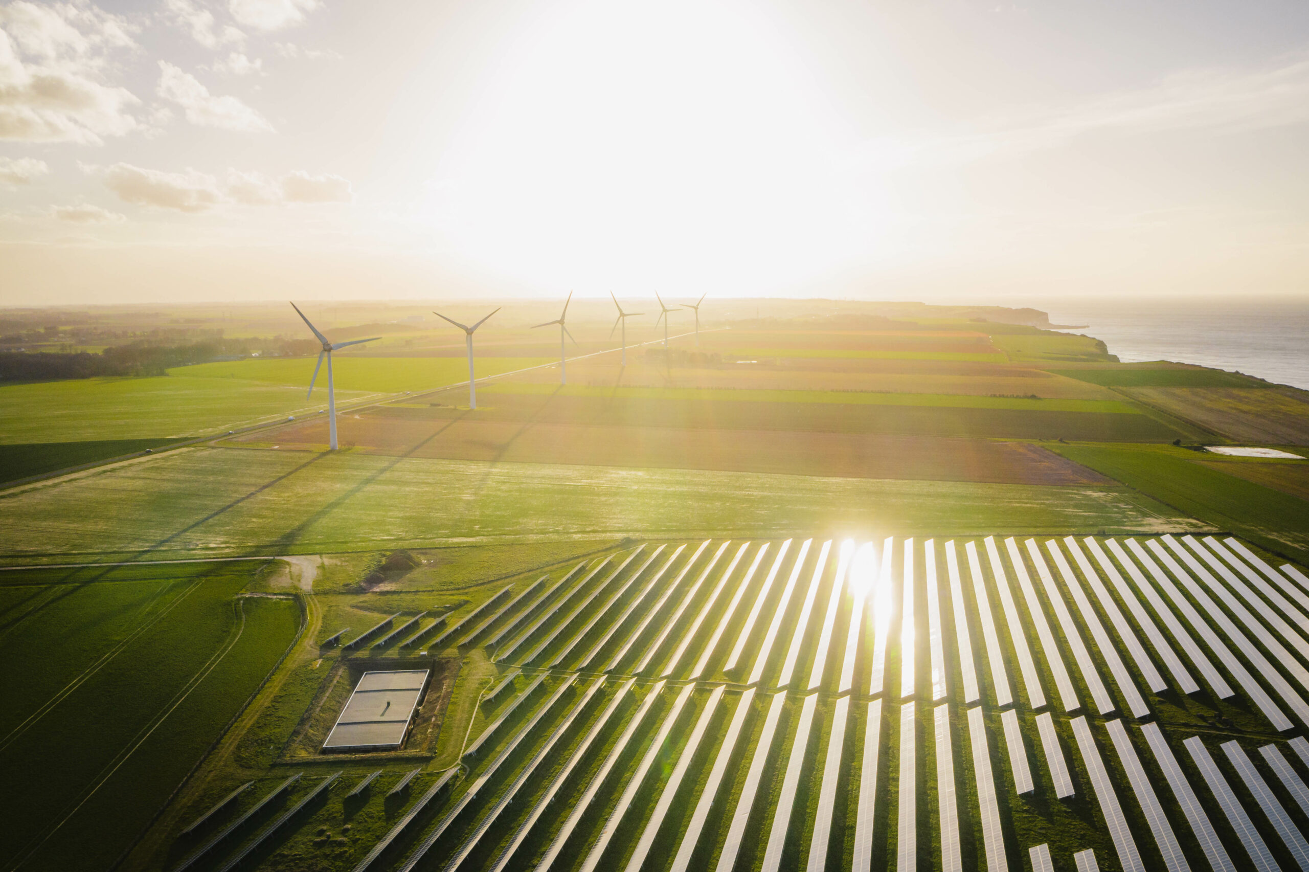 Wind turbines and solar panels farm in a field. Renewable green